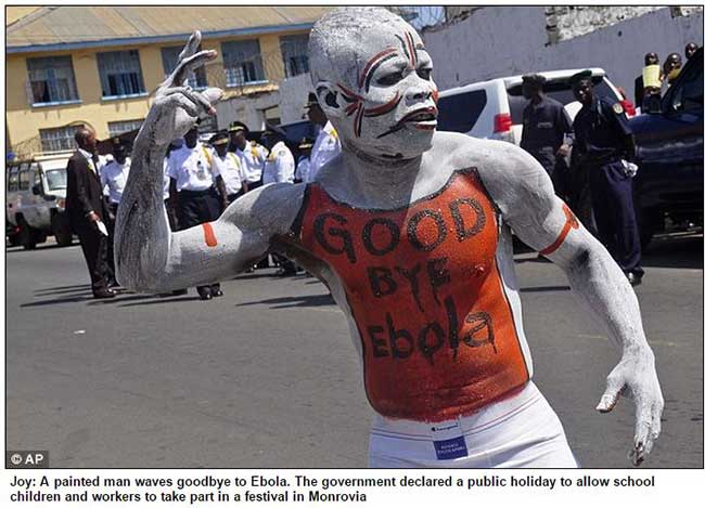 Painted man waves goodbye to Ebola